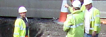 Demolition workforce on site wearing hard hats and high-vis jackets